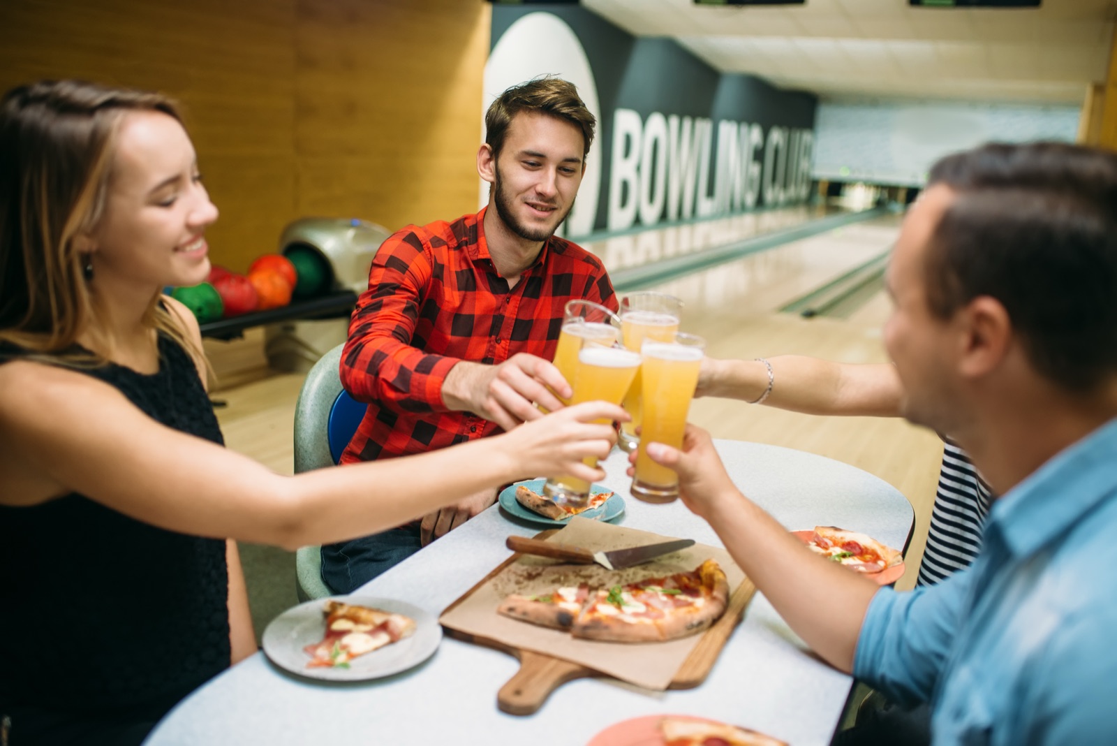 Bowling team celebrating with food and drinks