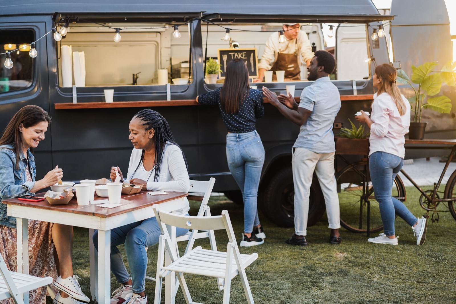 Customers enjoying food truck meals ordered through BlazeBite