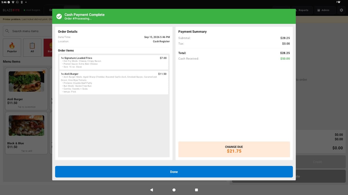 The BlazeBite terminal showing Cash Payment Complete with the order details and change due