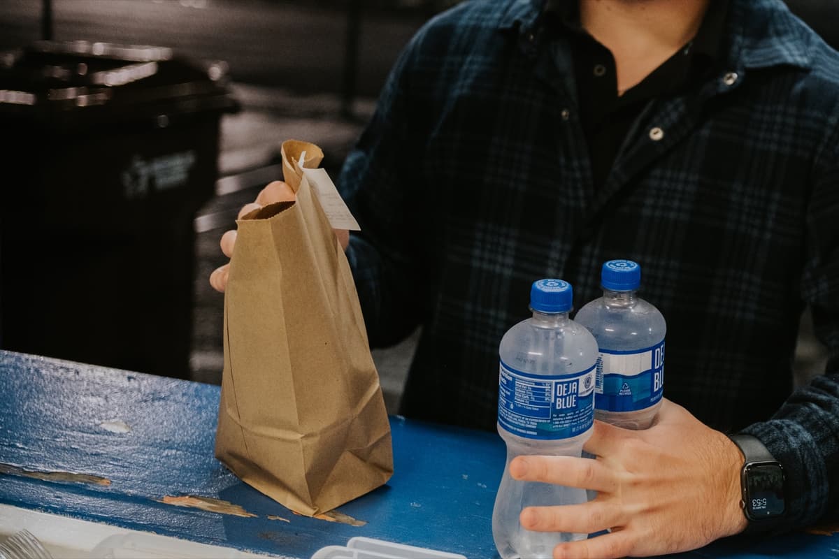A fan picking up a bagged order at the window
