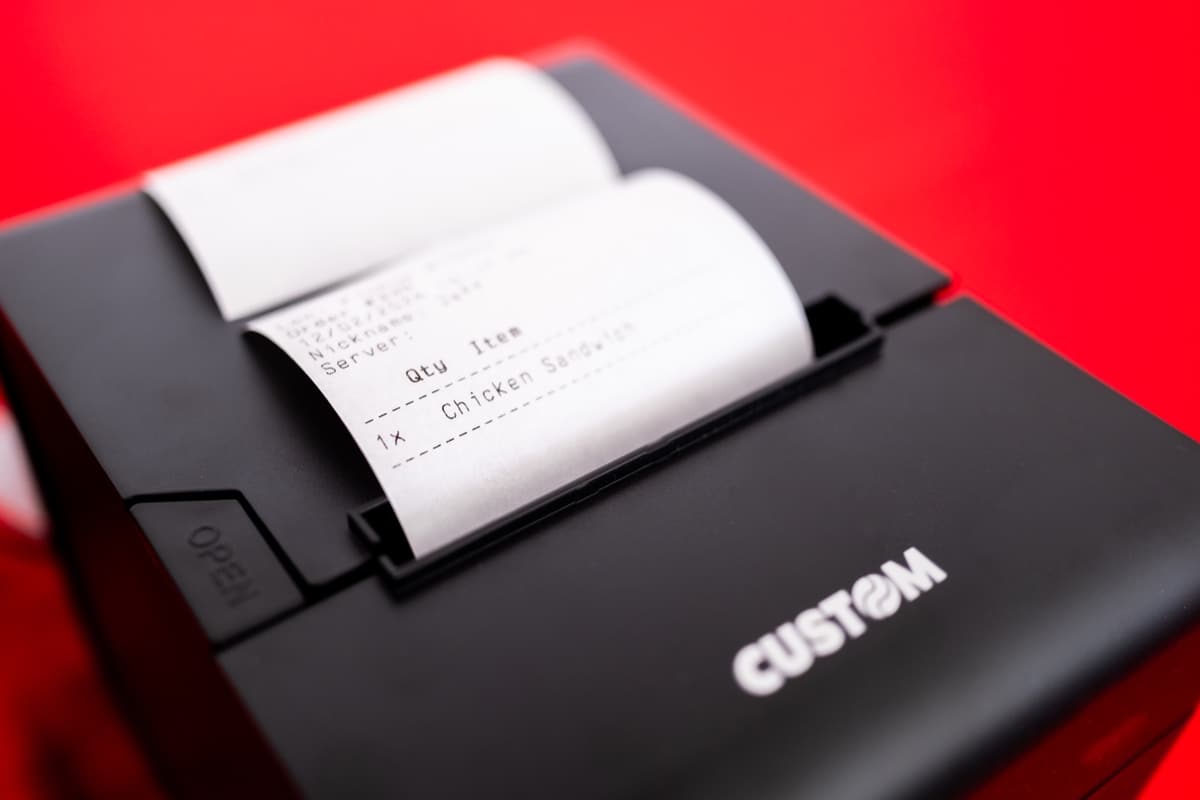 A kitchen ticket printing from a receipt printer