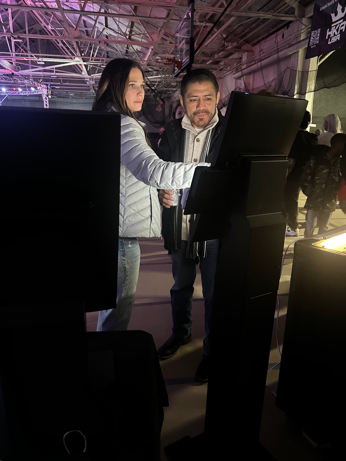 Hands on a BlazeBite kiosk screen at an event after dark